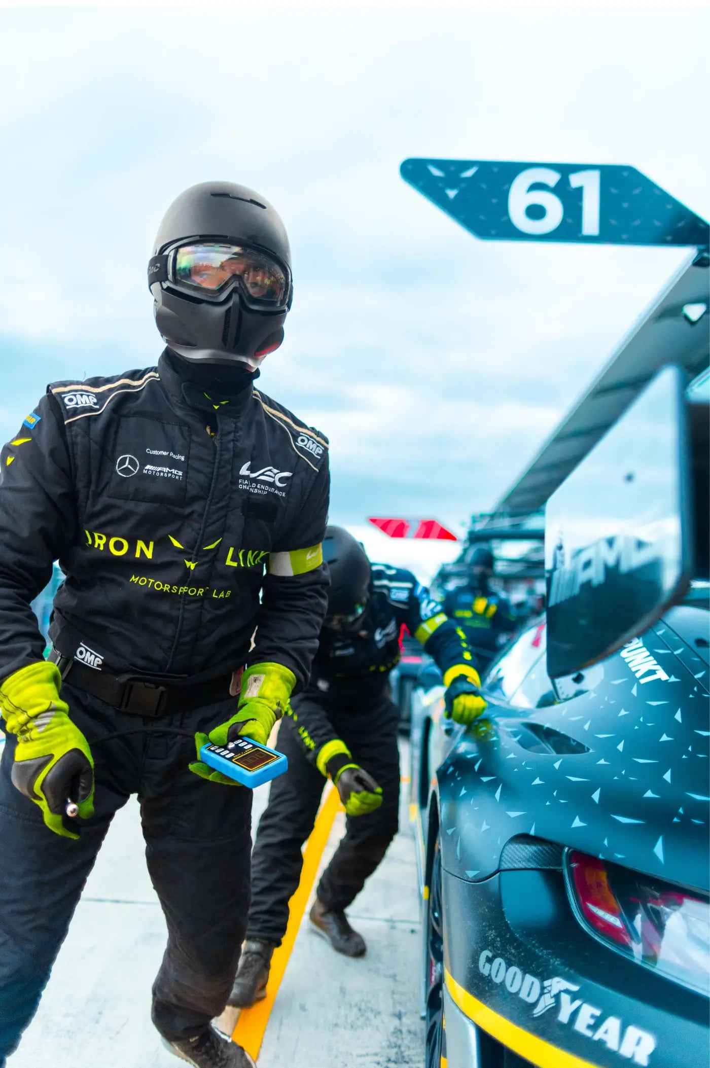 Measuring tire pressure in the Imola race pit stop.